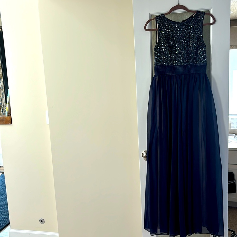 Maxi length baby gown with beaded detail on the top.